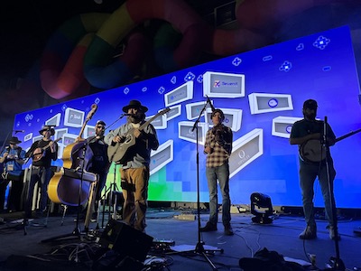 Justin and the boys on-stage at EthDenver.