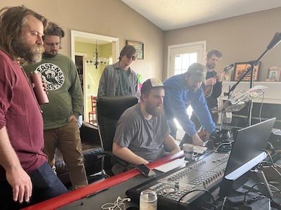 From left to right: Justin Holmes, Harry Clark, Christian Ward, Jake Stargel, Cory Walker, and Jakub Vysoky look on at the console at Stargel Studios.